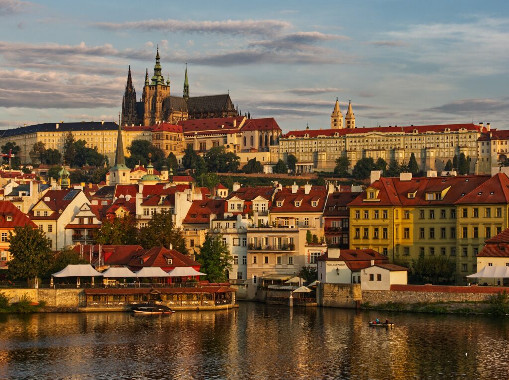 Prague skyline with Prague Castle and Vltava River at sunset