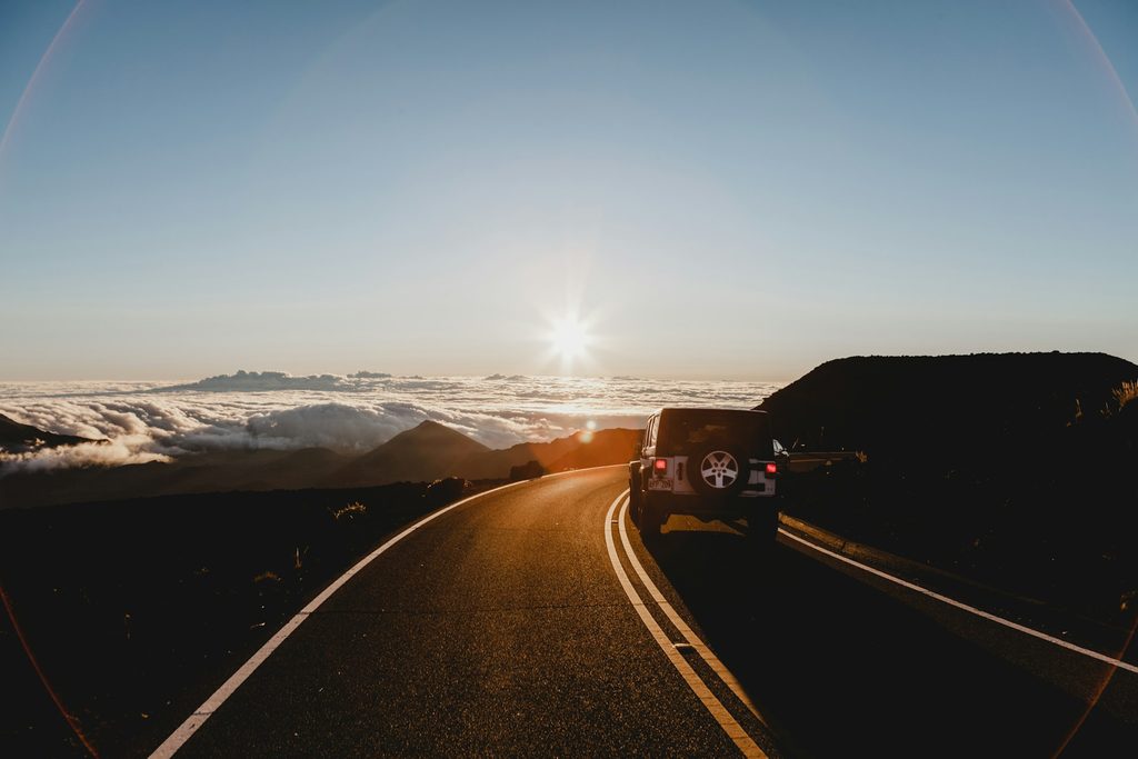 Car driving along a scenic mountain road during an autumn road trip in Europe